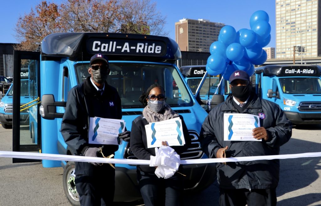 2020 Call‑A‑Ride Operators of the year standing in front of the new Call‑A‑Ride vans, holding their certificates. From left to right: Jerome, Barbara, Howell